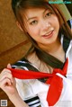 A woman in a sailor outfit posing for a picture.