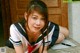 A woman in a school uniform laying on a table.