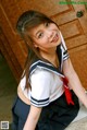 A woman in a school uniform posing for the camera.