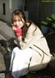 A woman sitting on the steps of a building.