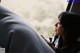 A woman sitting in a car looking out the window.