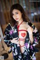 A woman in a kimono with a red heart on her chest.