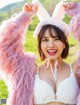 A woman in a pink bunny costume posing for a picture.