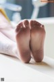 A close up of a person's bare feet on a table.