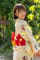 A woman in a kimono is posing for a picture.