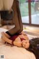 A woman laying on top of a bed in lingerie.