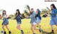 A group of young women running in a field.