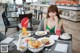 A woman sitting at a table with a plate of food.