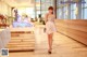 A woman in a short dress standing in front of a counter.